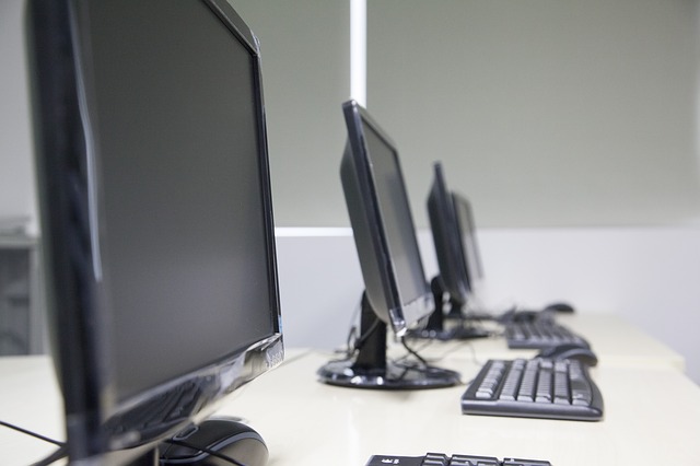 three computers in empty classroom