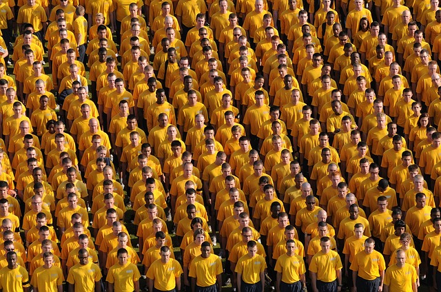 large crowd of men all looking the same with yellow shirts