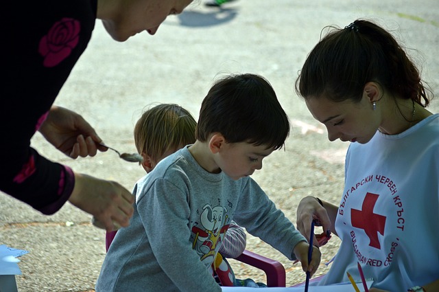 woman volunteer helping a boy