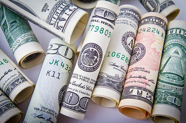 various amounts of money rolled up