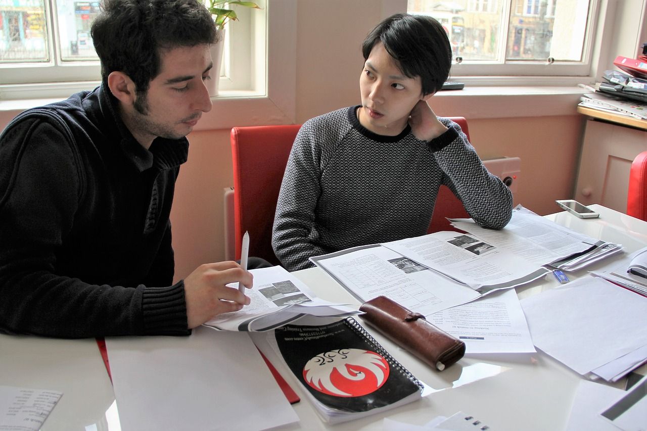 teacher and student student talking with teraching at her office
