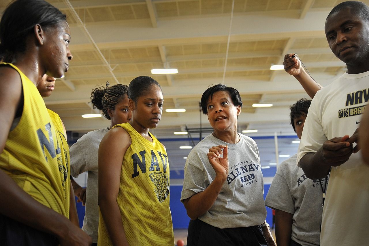 women's basketball team African American female coach talking to women's basketball team