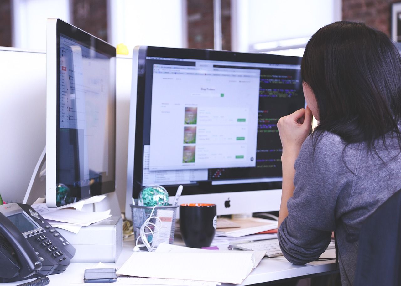 woman with Doctoral Degree working at computer screen in a business office