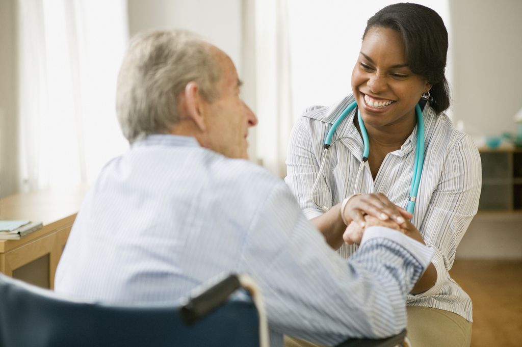 nurse and elder African American nurse with elderly man