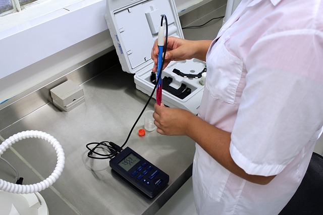 lab technician in lab coat working with medical device