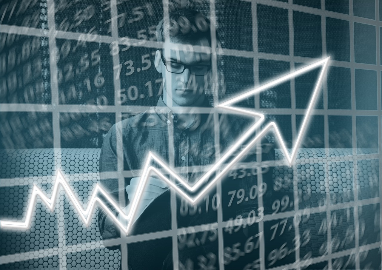 man writing numbers on clear board with arrow showing increasing trend
