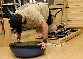 man doing physical therapy man with artifical legs doing physical therapy in a laying-down position